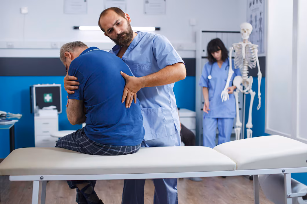 Chiropractor assisting a patient during a care session
