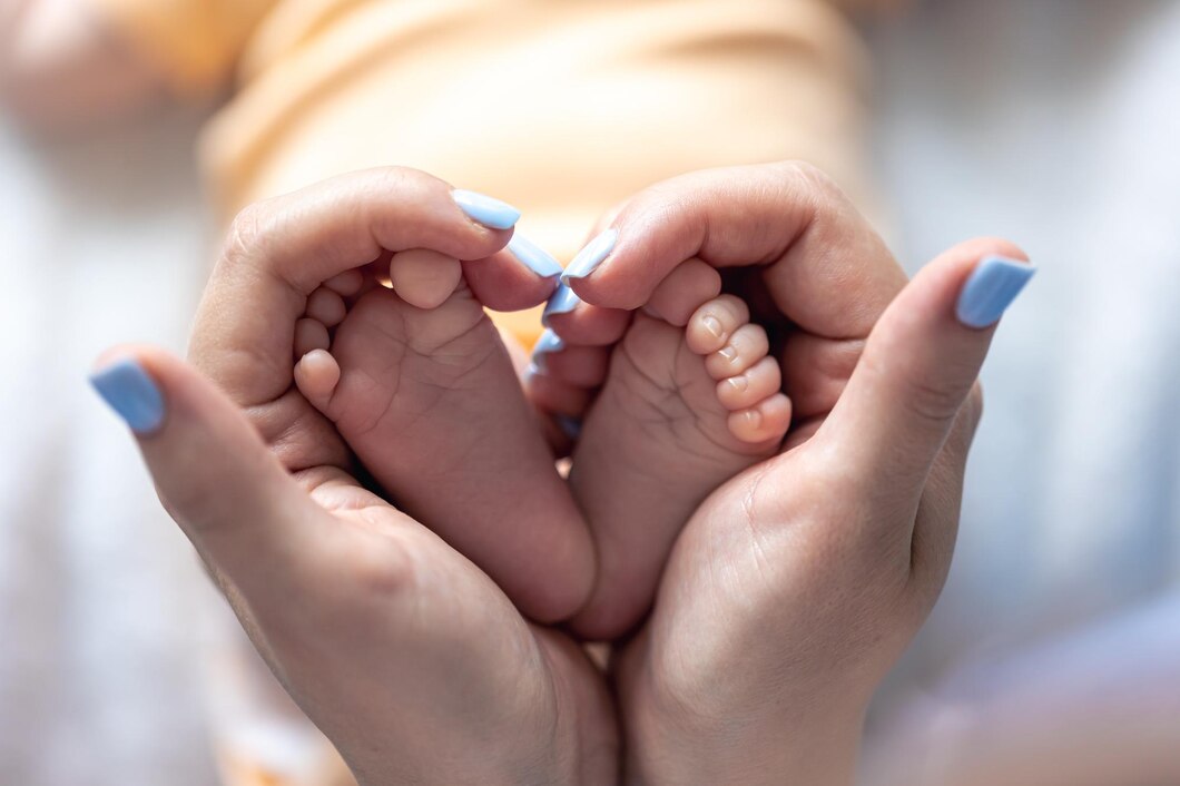 Parent gently holding a newborn baby's feet